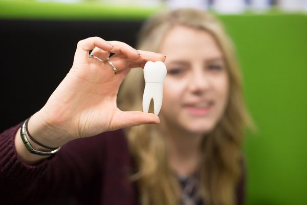 Tyler with the tooth shaped USB which forms part of the dental phobia kit she designed